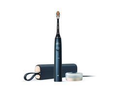 Philips Sonicare 9900 Prestige toothbrush in navy with travel case and charging glass on white background
