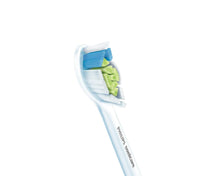 Angled white replacement brush head with blue and green bristle inserts