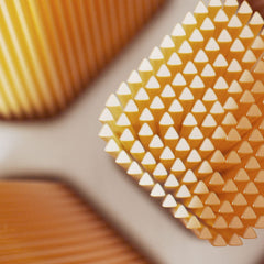 Close up of three golden triangular bristle toothbrush heads showcasing texture for Philips Sonicare Premium brush heads