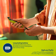 PHILIPS wet and dry beard shaver green handheld being plugged in to charge showing long lasting battery