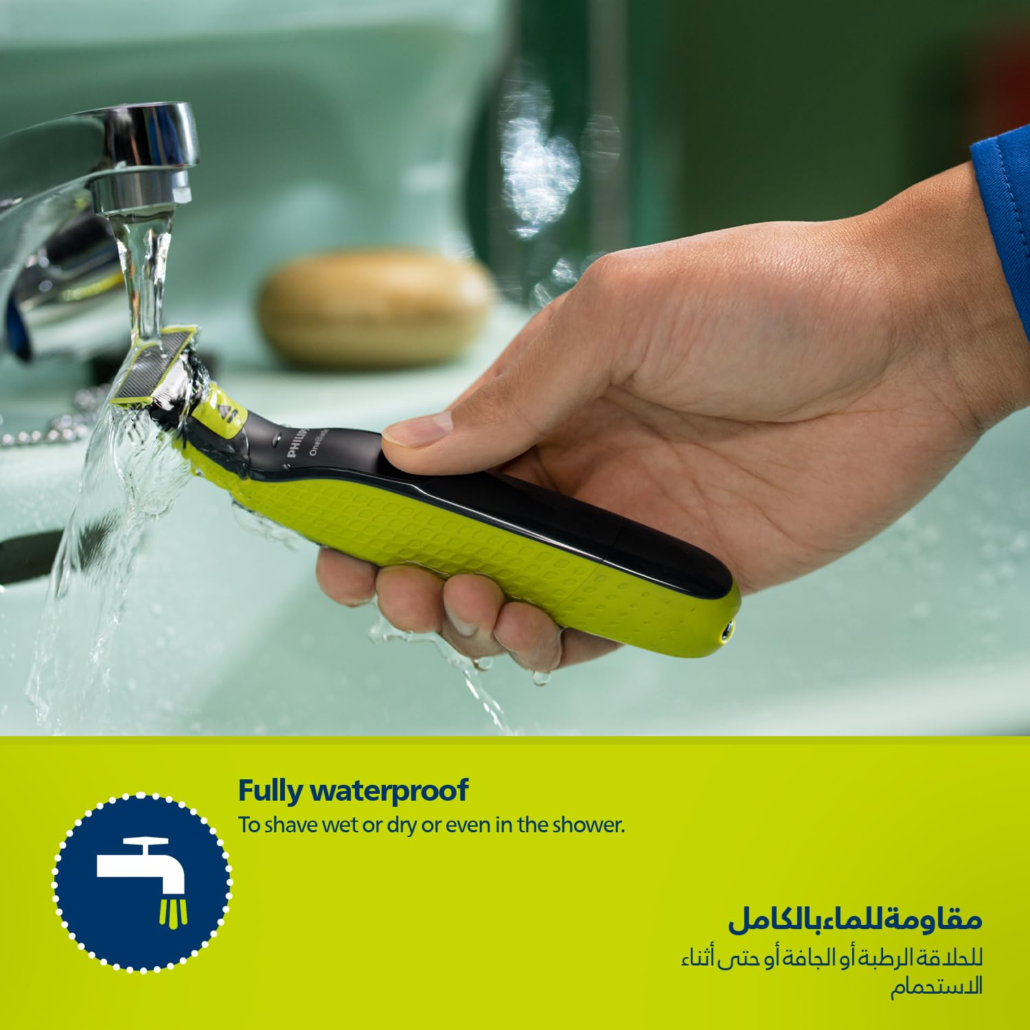 PHILIPS wet and dry beard shaver with green grip being rinsed under bathroom faucet showing waterproof use