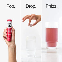 Electrolyte tablets tube in hand with text prompts and glass of colored drink