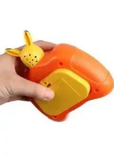 Orange Pikachu pop-it fidget toy with yellow base panel, hand-held view