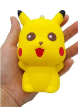 Pikachu yellow stress relief squeeze toy with smiling face held in hand