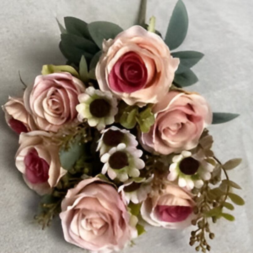 Huitich pink artificial flower arrangement with roses and greenery on a light background
