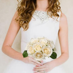 Huitich pink artificial silk rose bouquet held by bride in white dress with rhinestone neckline