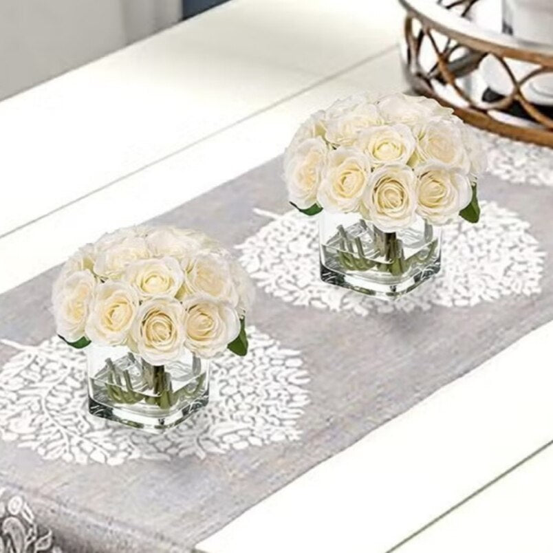 Huitich pink artificial silk rose bouquet in clear square glass vases displayed on a decorative table runner