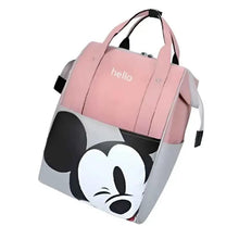 Pink travel diaper bag angled view with top handle, side straps, and cartoon mouse face panel.
