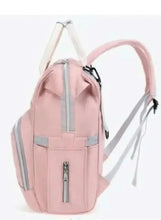 Pink baby travel backpack side view with vertical zip pocket and adjustable strap