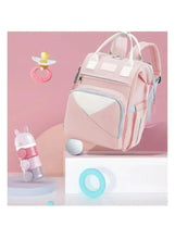 Pink baby travel backpack angled view with front zip pouch and top carry handle