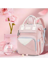 Pink baby travel backpack with front zip pocket, heart-shaped panel, and twin top handles