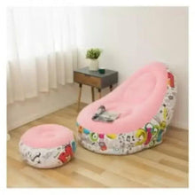 Pink inflatable lounge chair with colorful graphic print and round footrest, side view
