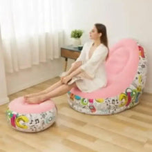 Pink inflatable lounge chair with footrest, colorful graphic print on vinyl surface