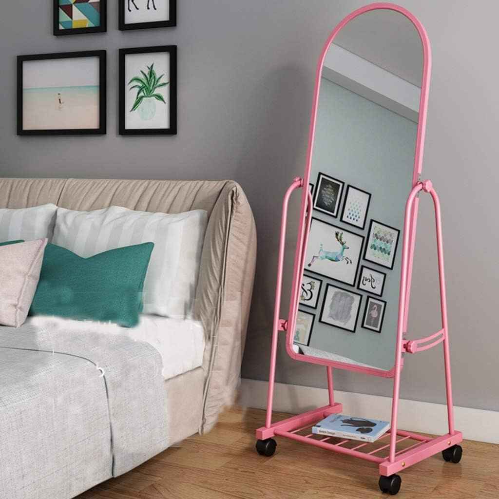 Huitich rotatable floor mirror with wheels in pink frame next to bed in modern bedroom
