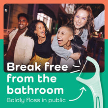 Mint-colored dental floss pick held near teeth.
