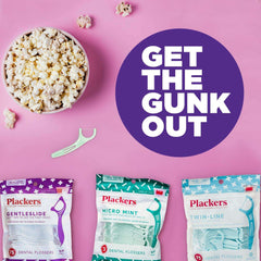 Plackers dual grip dental flossers three packages with mint floss pick and popcorn on pink background