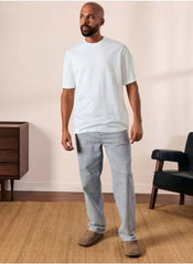 Man wearing plain white t shirt for men XL by Huitich paired with light gray pants and brown shoes
