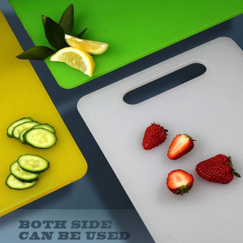 Huitich plastic chopping board with handle in yellow green and white with sliced fruits and vegetables