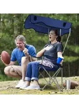 Folding beach chair with navy canopy, padded seat, and metal cross-brace legs