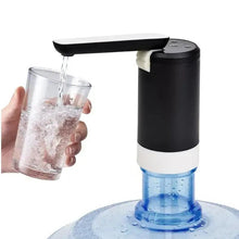 Portable electric water dispenser pump with water flowing into clear cup