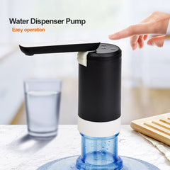 Huitich portable electric water dispenser pump in black being operated with a finger pressing the top button