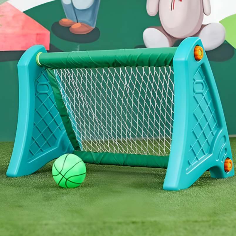 Portable football goal for kids made of plastic in blue with net and green ball on grass