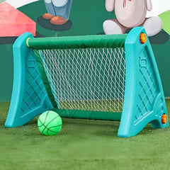 Portable football goal for kids made of plastic in blue with net and green ball on grass
