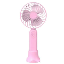 Pink portable handheld fan with circular grille and charging base