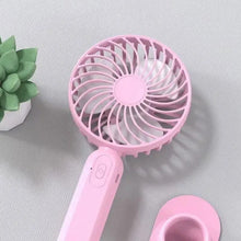 Pink portable handheld fan with charging stand and circular grille head
