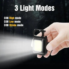 Black mini LED pocket light held in hand, bright white square panel, switch button