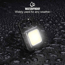 Black waterproof mini LED pocket light with glowing square panel and water droplets