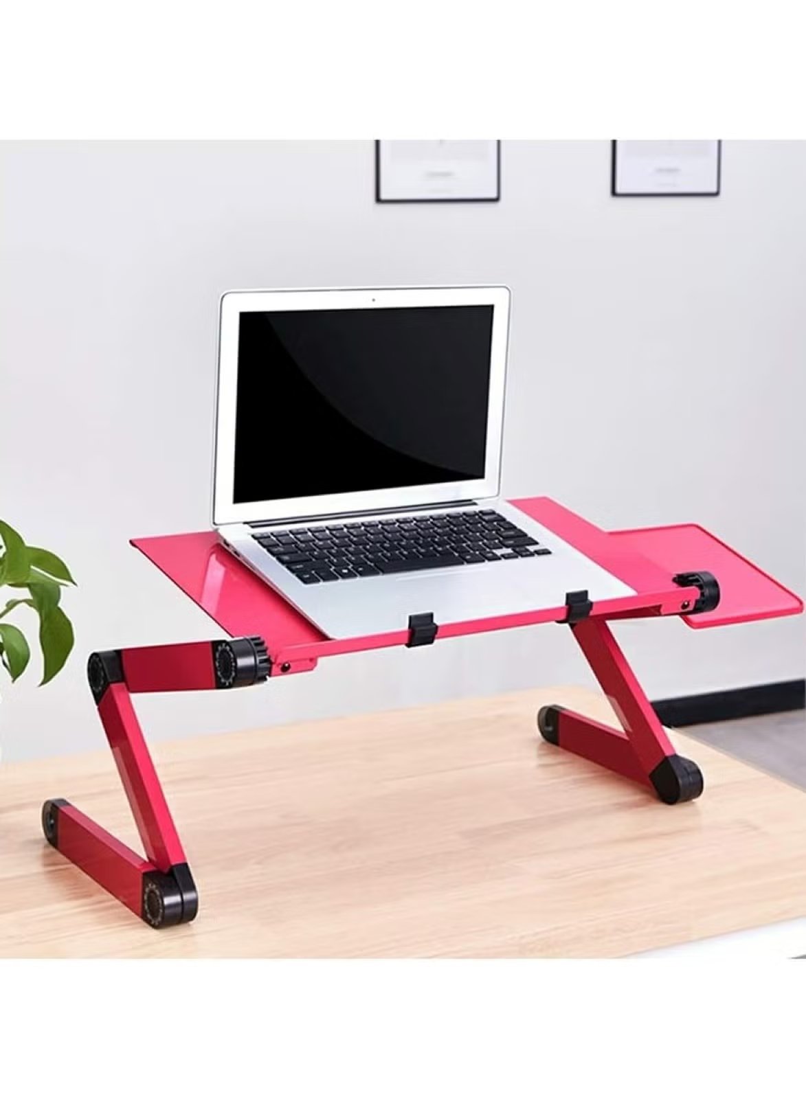 Red aluminum folding laptop table by Huitich with adjustable legs and a laptop on top