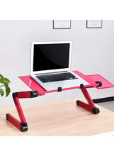 Adjustable laptop table with pink platform, black rollers, and laptop on top
