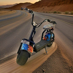 Winner Sky powerful electric scooter with fat tires parked on a desert road with rocky hills in the background