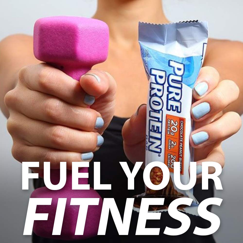 Hands holding a pink dumbbell and Pure Protein bar wrapper with Fuel Your Fitness text protein bar chocolate peanut butter