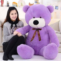 Huitich purple teddy bear 60cm with soft plush fur and brown ribbon sitting next to smiling woman