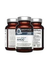 Three AHCC immune support supplement bottles with amber liquid and silver caps