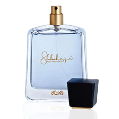 Rasasi Shuhrah for Men perfume bottle with clear blue liquid and black cap removed