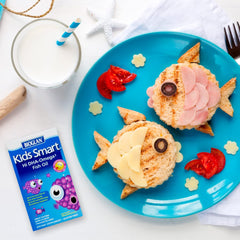Creative plate of fish-shaped sandwiches featuring Kids Omega 3 fish oil supplements by Real Health