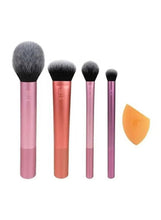 Multi-use makeup brush set with four pink handled face brushes and one orange sponge