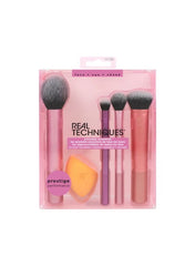 Real Techniques multi use brush set with four essential makeup brushes and a blending sponge in a pink package