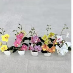 Huitich artificial flowers featuring realistic faux orchids for home decor in various colors with green leaves in white pots