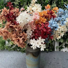 Realistic orange rose bouquet for wedding with multicolor artificial flowers in decorative vase
