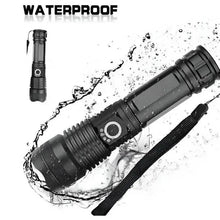 Black flashlight with adjustable focus ring, wrist strap, water splash around the body