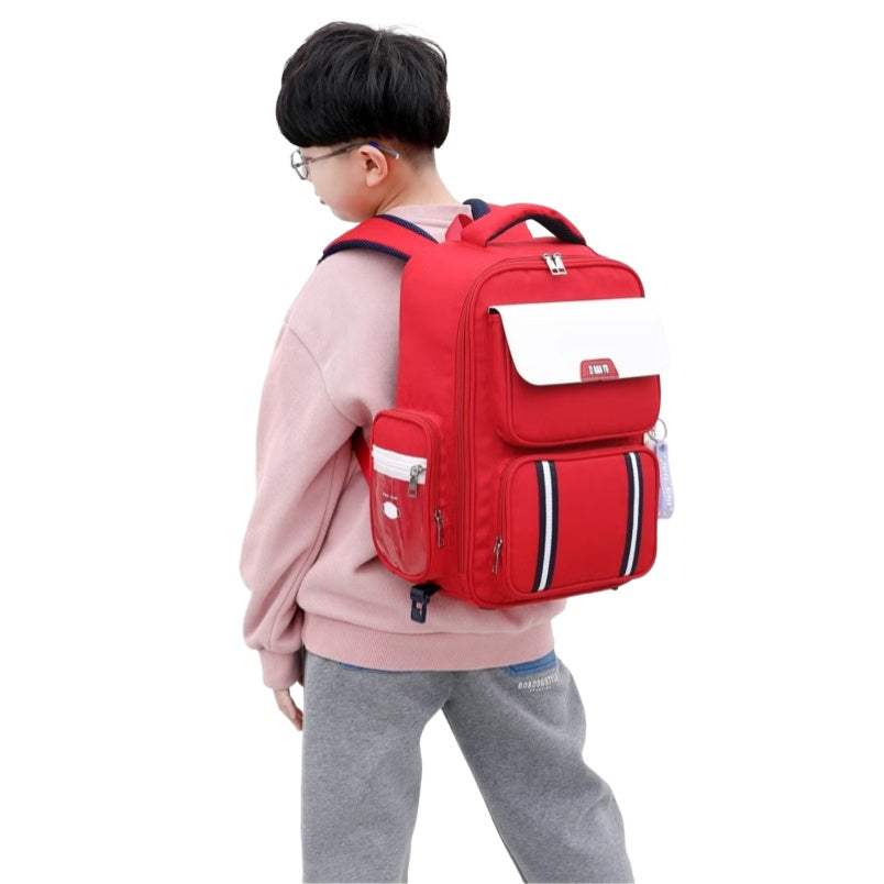 Child wearing red six wheel trolley school bag by Huitich with multiple compartments and side pockets