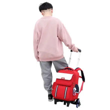Red rolling school trolley bag with front pocket and side wheels, back view