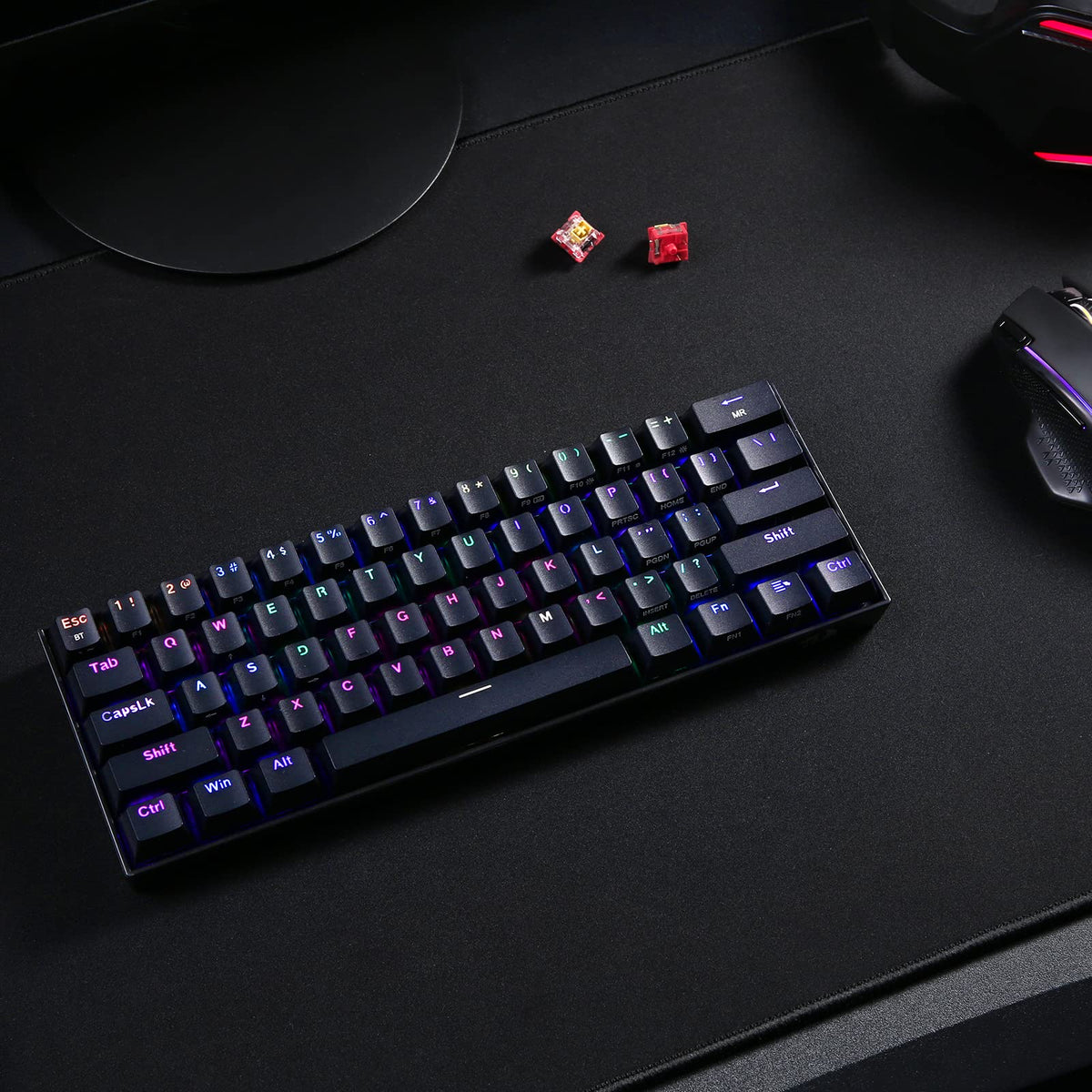 Redragon compact mechanical keyboard for Windows Mac Android with RGB backlit keys on black desk