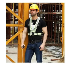 Lime green reflective safety belt worn over dark shirt with black buckle straps