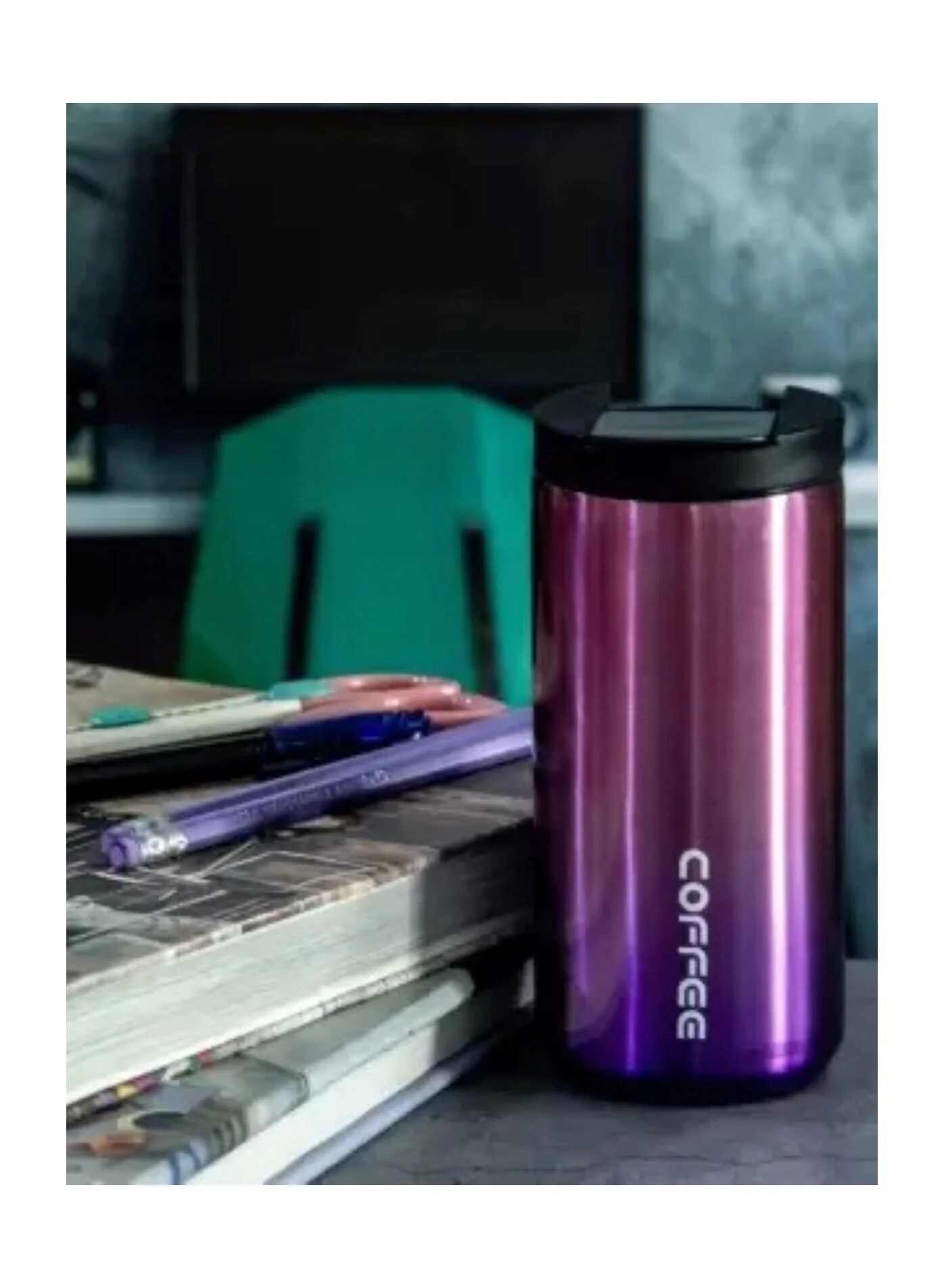 Huitich reusable coffee travel mug in metallic purple with black lid on desk beside notebooks and pens
