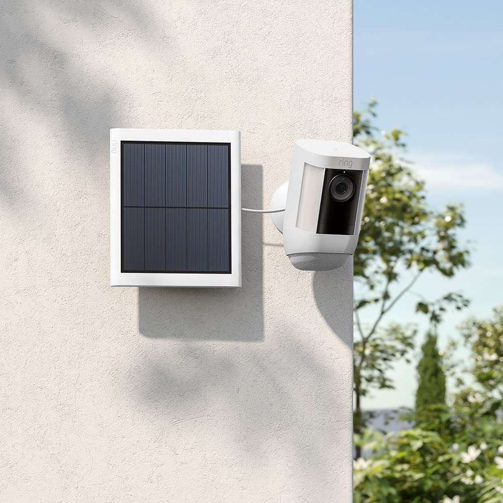 Ring solar panel 2nd generation mounted on wall next to Ring security camera with outdoor scenery